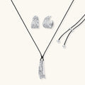 Textured silver jewelry set with floral engravings featuring adjustable cord necklace and matching hoop earrings