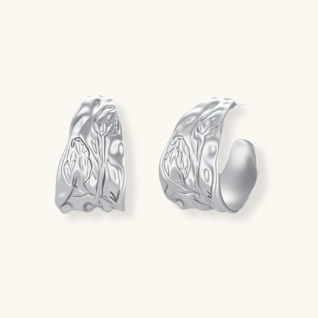 Textured silver jewelry set with floral engravings featuring adjustable cord necklace and matching hoop earrings