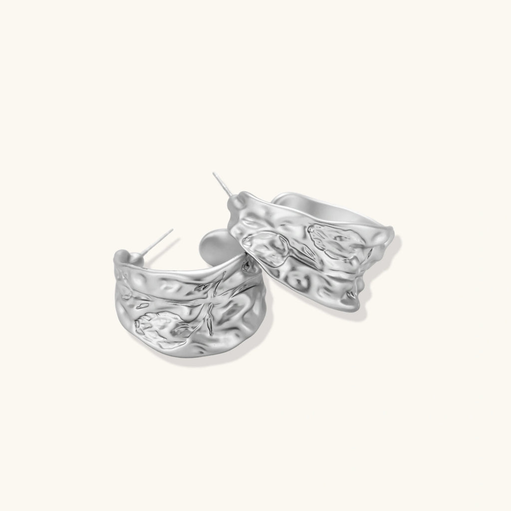 Textured silver jewelry set with floral engravings featuring adjustable cord necklace and matching hoop earrings